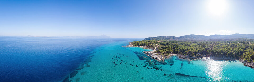 wide-shot-aegean-sea-coast-with-blue-transparent-water-greenery- - poltravelers